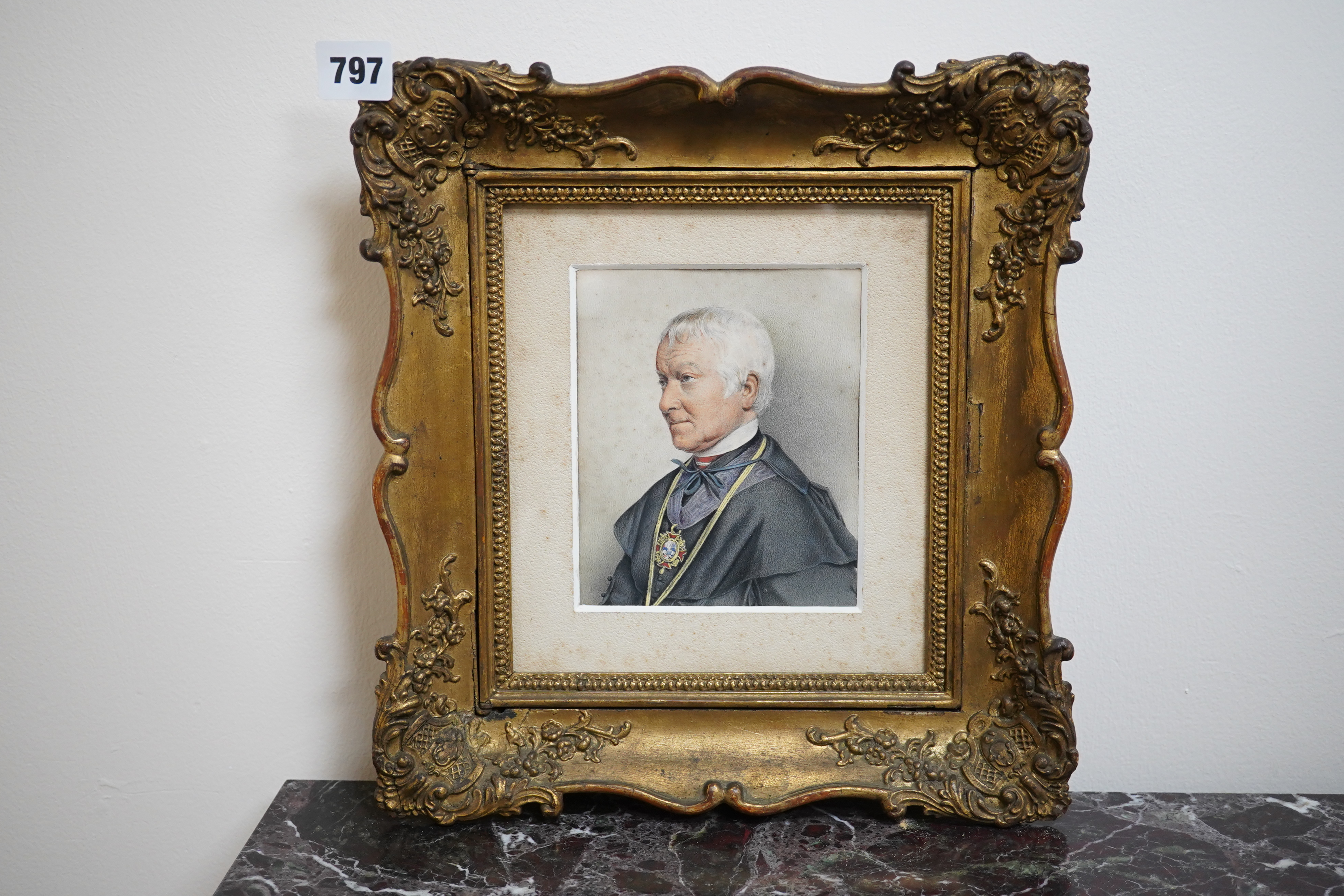 A 19th century hand coloured engraving, Portrait of a clerical gentleman, 14 x 11cm, housed in ornate gilt frame. Condition - fair, some foxing